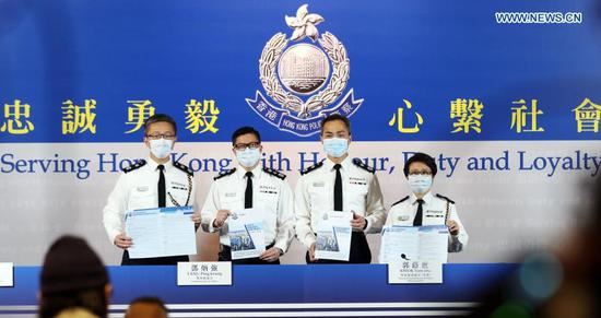 Chris Tang Ping-keung (2nd L), Commissioner of Police of the Hong Kong Special Administrative Region (HKSAR) government, attends a press conference in Hong Kong, south China, Feb. 2, 2021. The Hong Kong police have arrested 97 people since June 2020 on suspicion of breaching the national security law in Hong Kong, Chris Tang Ping-keung said Tuesday. (Xinhua/Li Gang)